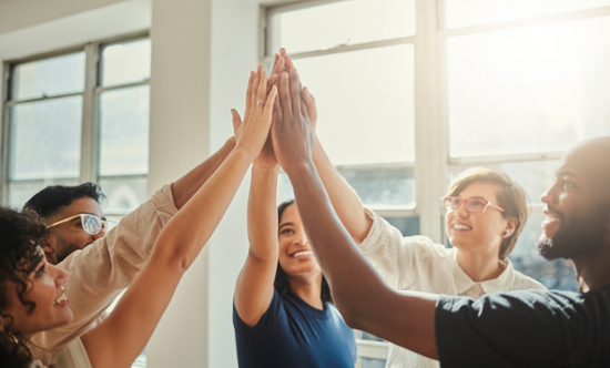 Group of people high fiving.