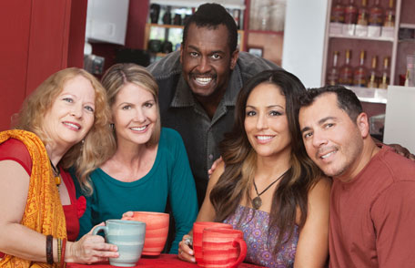 Group of adults drinking coffee and smiling
