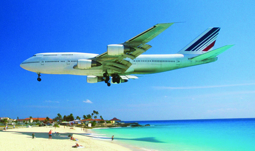 Plane flying low over beach